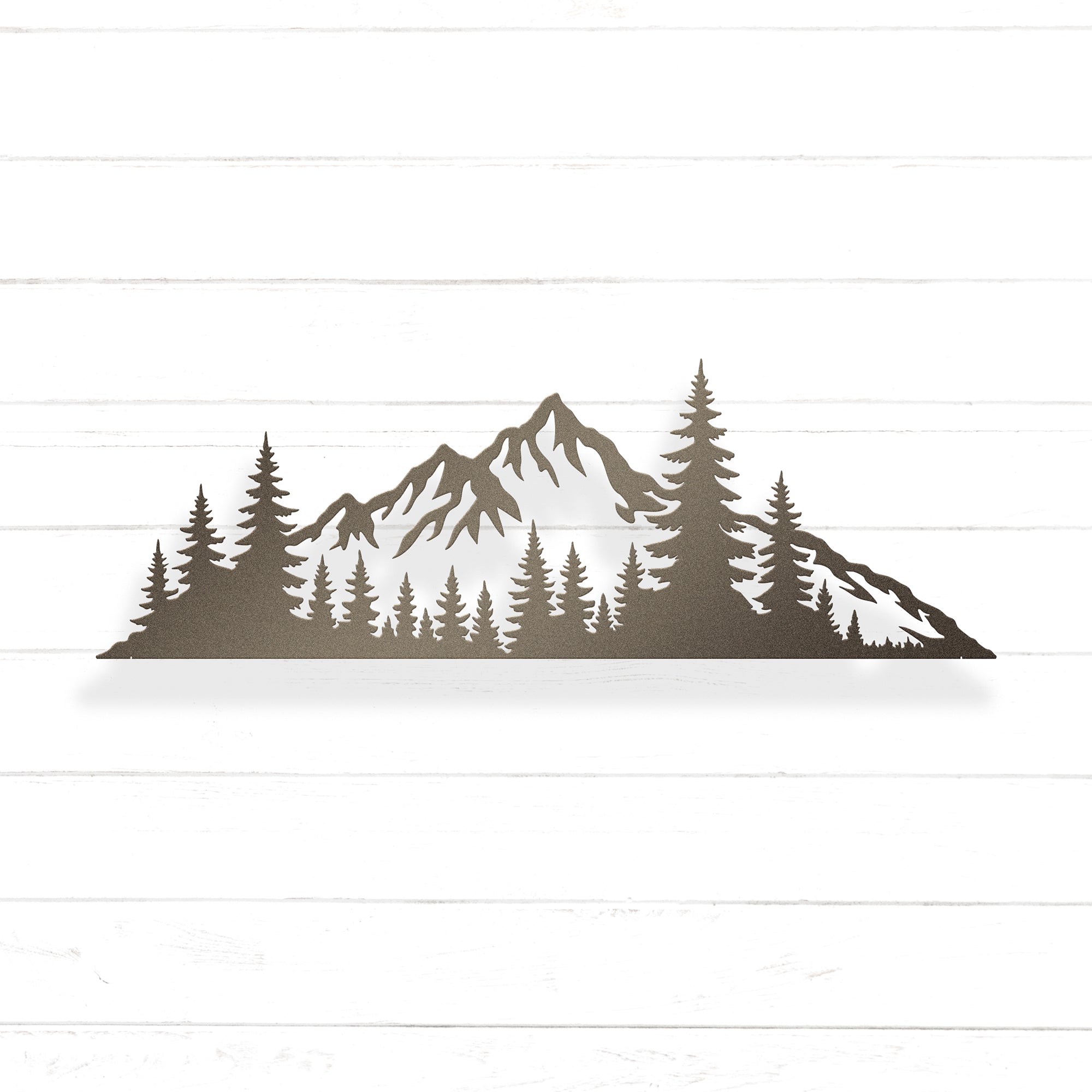 A silhouette of a mountain range with pine trees in the foreground.