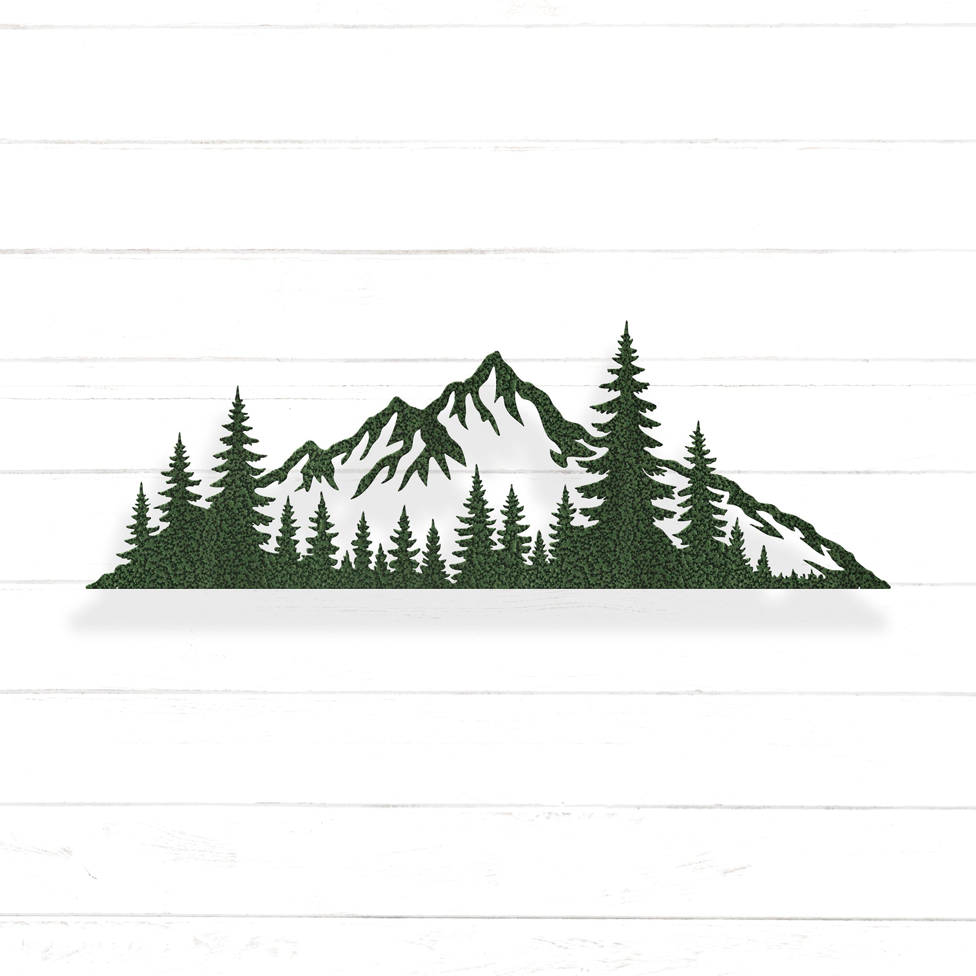 A silhouette of a mountain range with pine trees in the foreground.