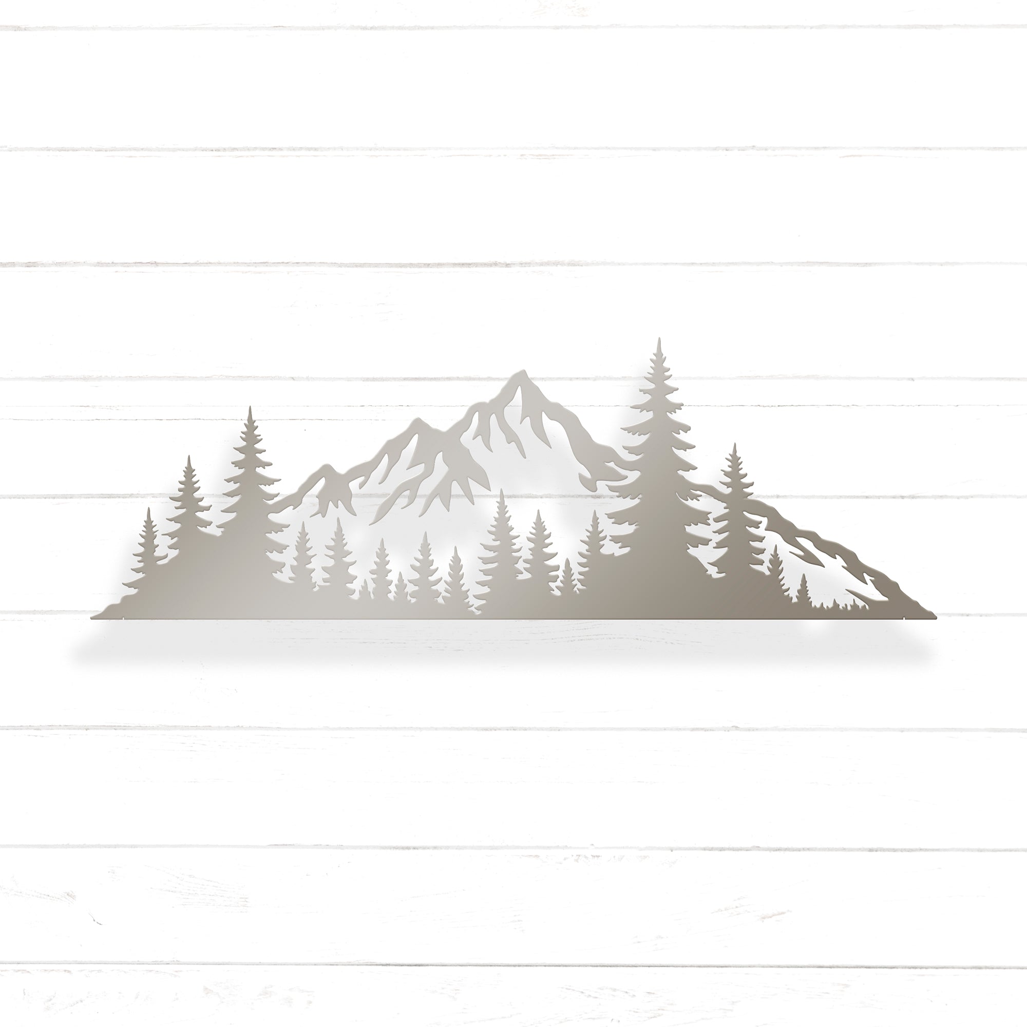 A silhouette of a mountain range with pine trees in the foreground.