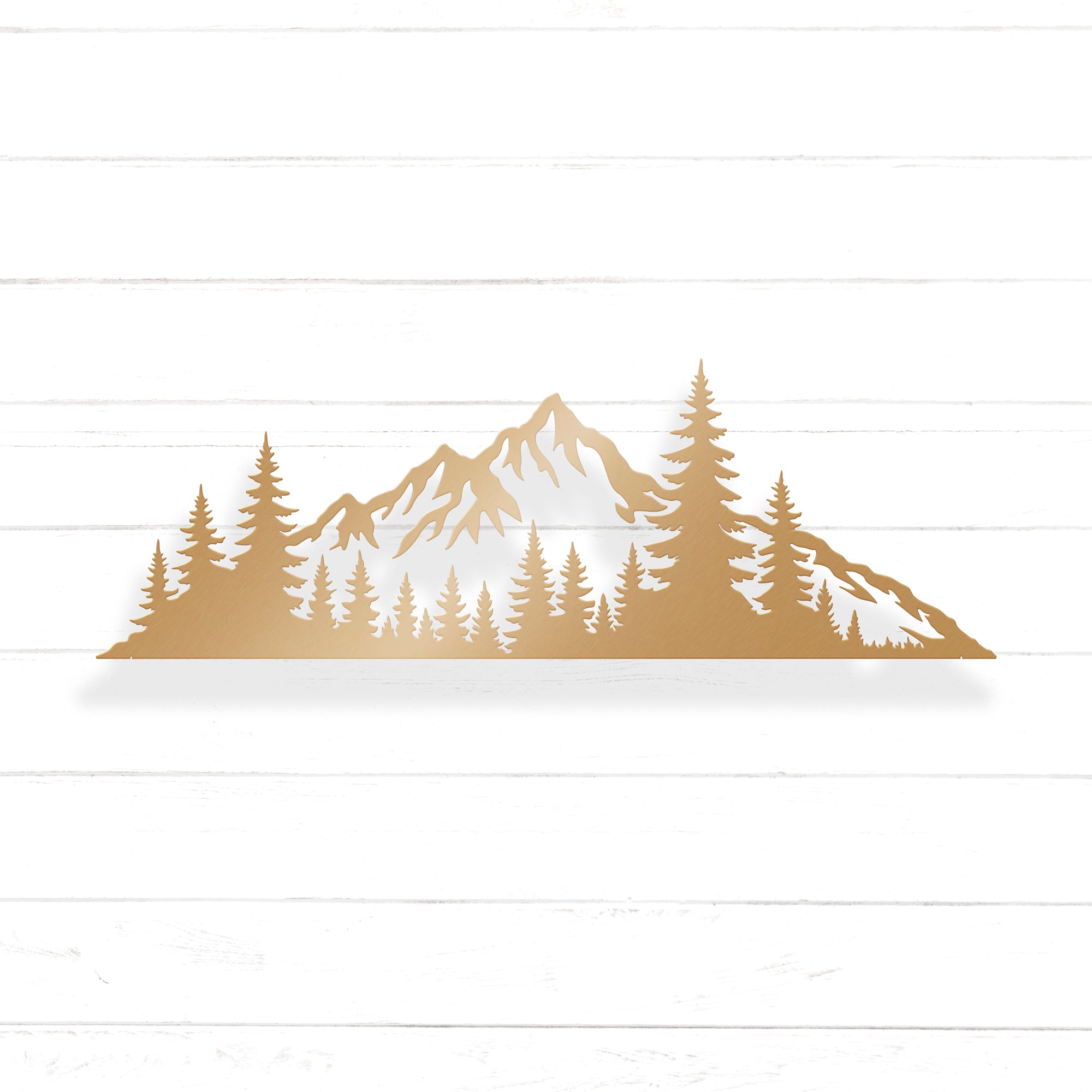 A silhouette of a mountain range with pine trees in the foreground.