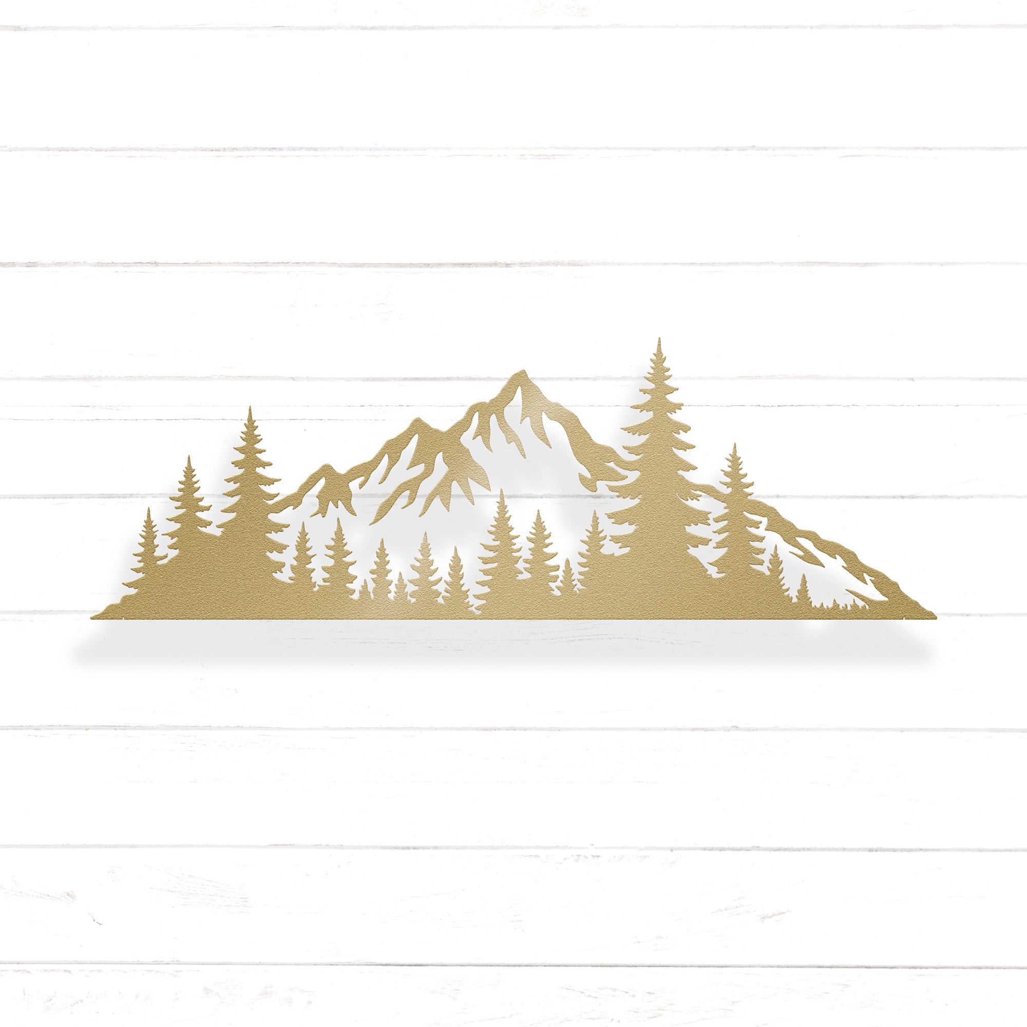 A silhouette of a mountain range with pine trees in the foreground.