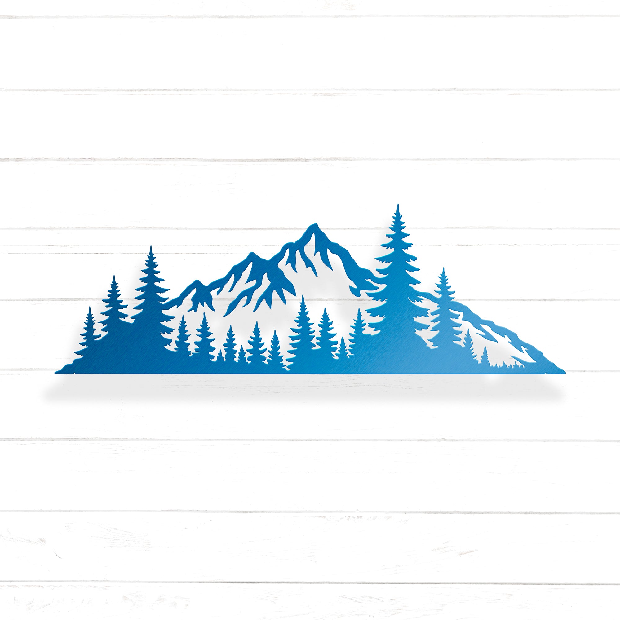 A silhouette of a mountain range with pine trees in the foreground.