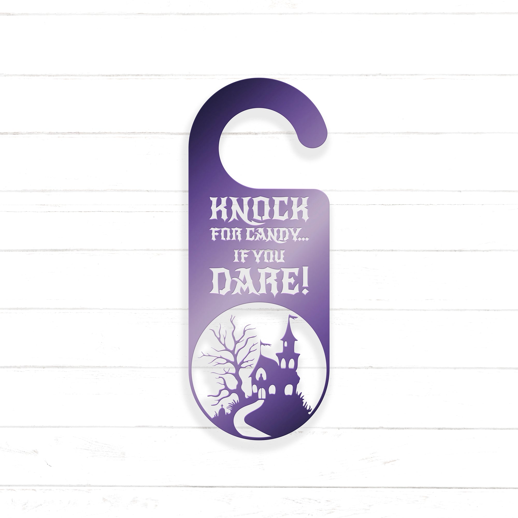 A purple door hanger with a castle silhouette and the text "KNOCK FOR CANDY... IF YOU DARE!" printed on it.
